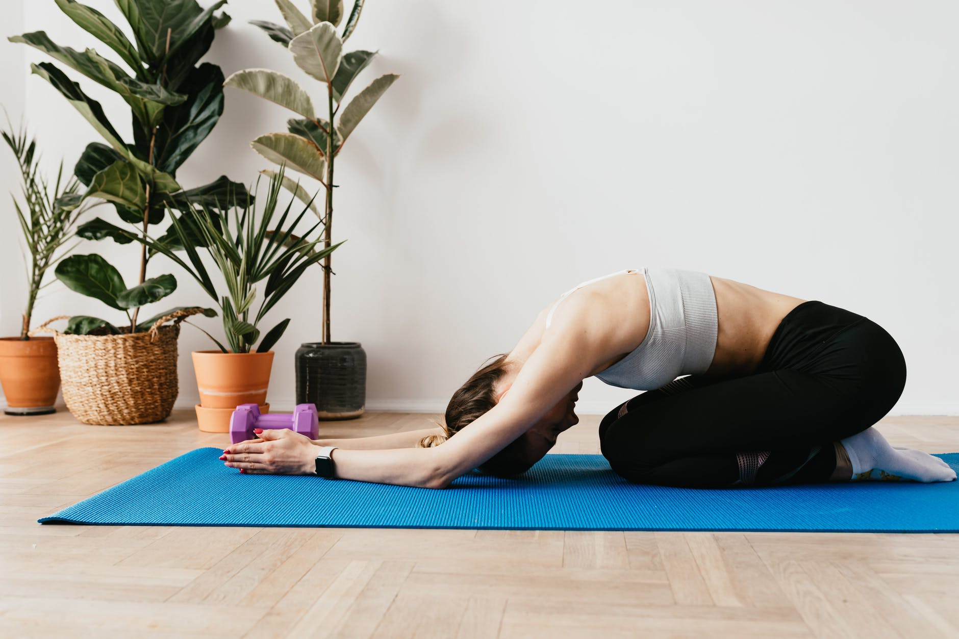 slim sportswoman stretching in child pose